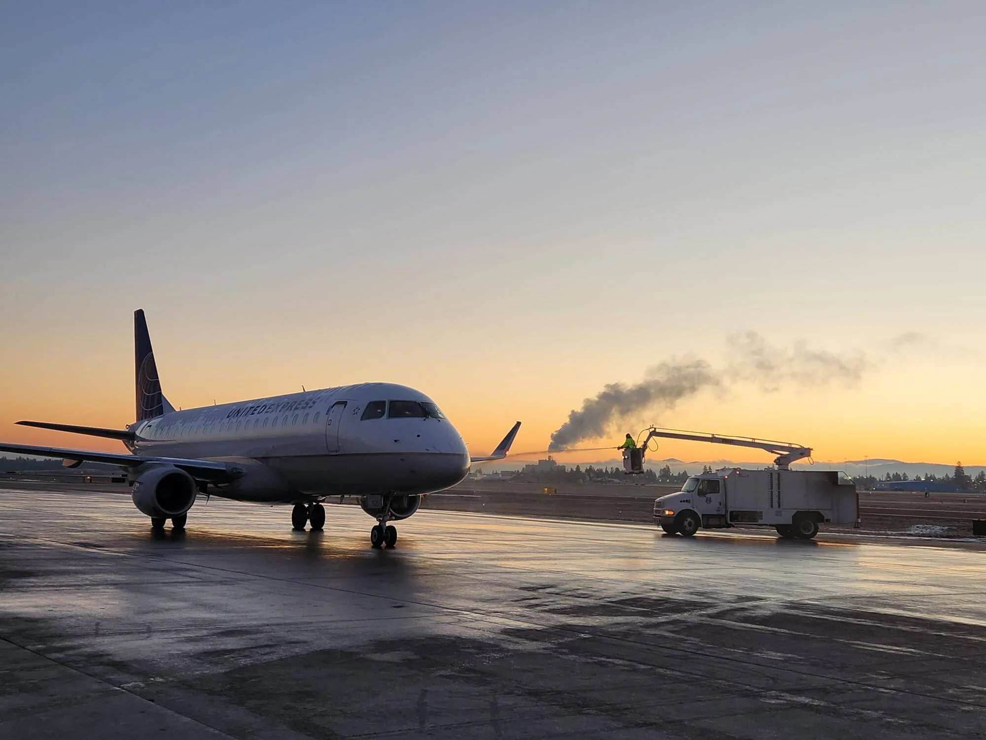 de-icing a plane on runway